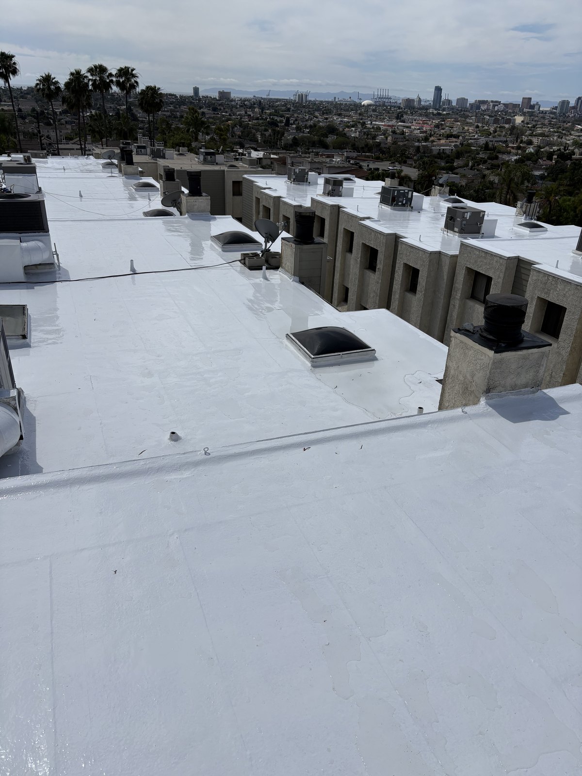 Final inspection view of the completed reflective silicone roof restoration in Signal Hill.
