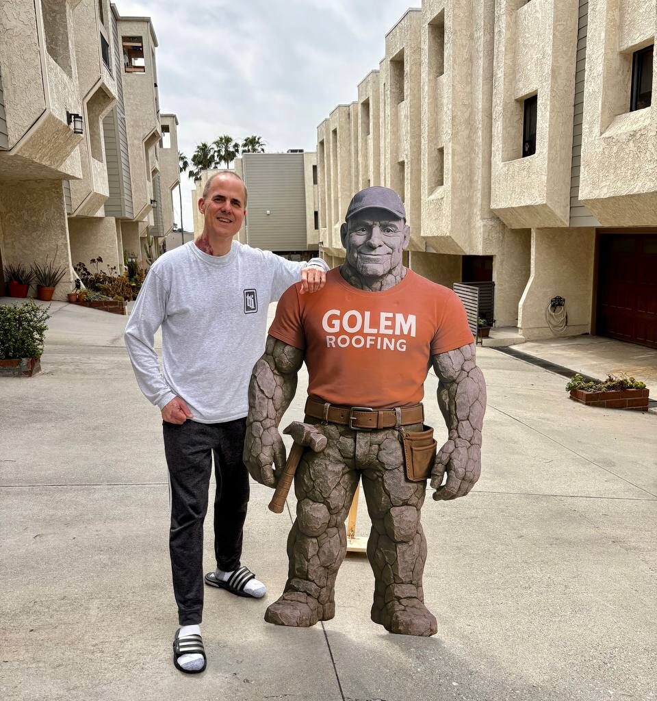 Golem Roofing team and brand mascot on site at the Signal Hill HOA roof restoration project.