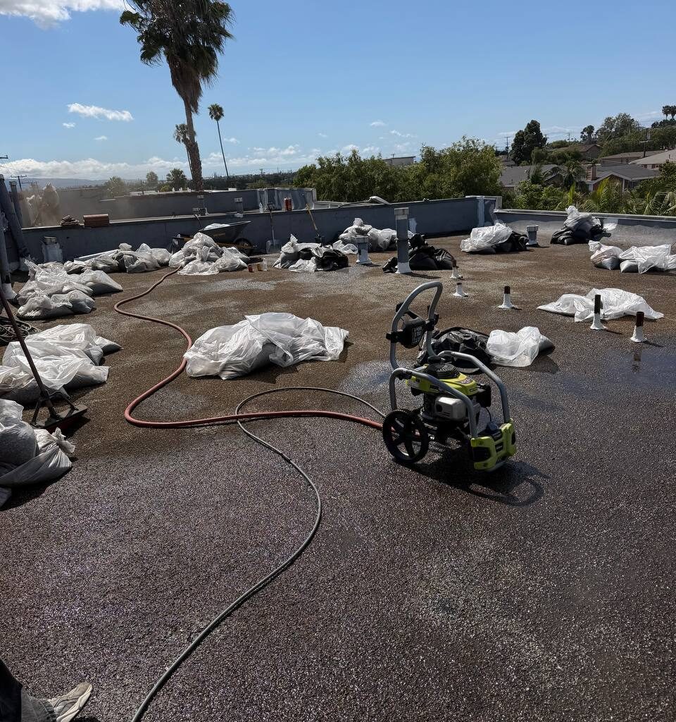 Existing tar and gravel apartment roof before restoration in Long Beach.