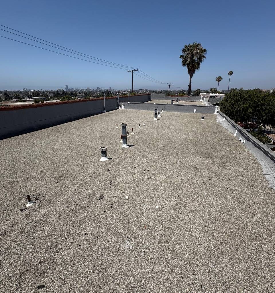 Prepared roof deck after gravel removal and cleaning before reinforced coating.